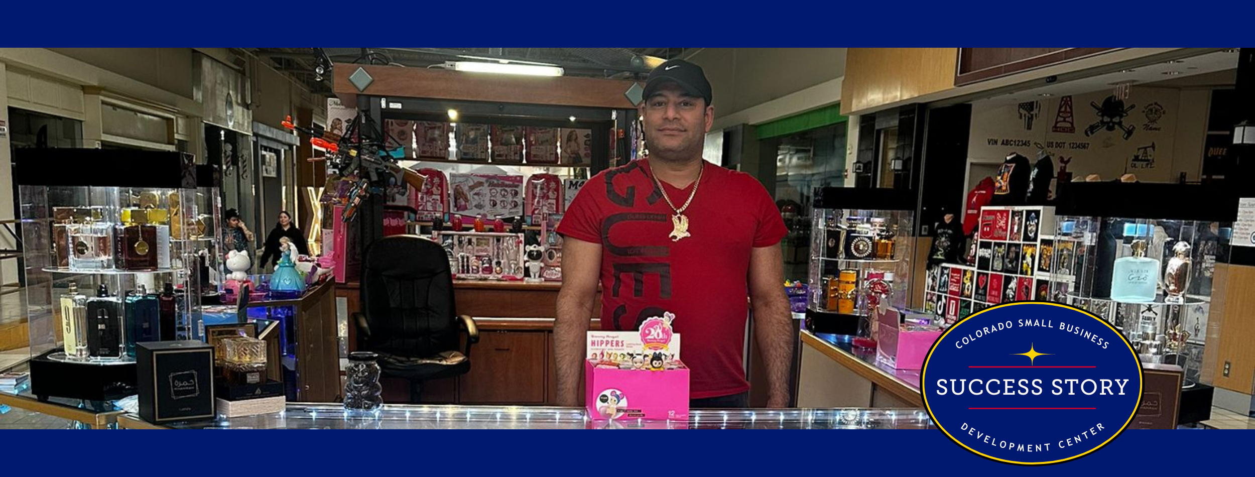 a person in a red shirt standing in front of a store.