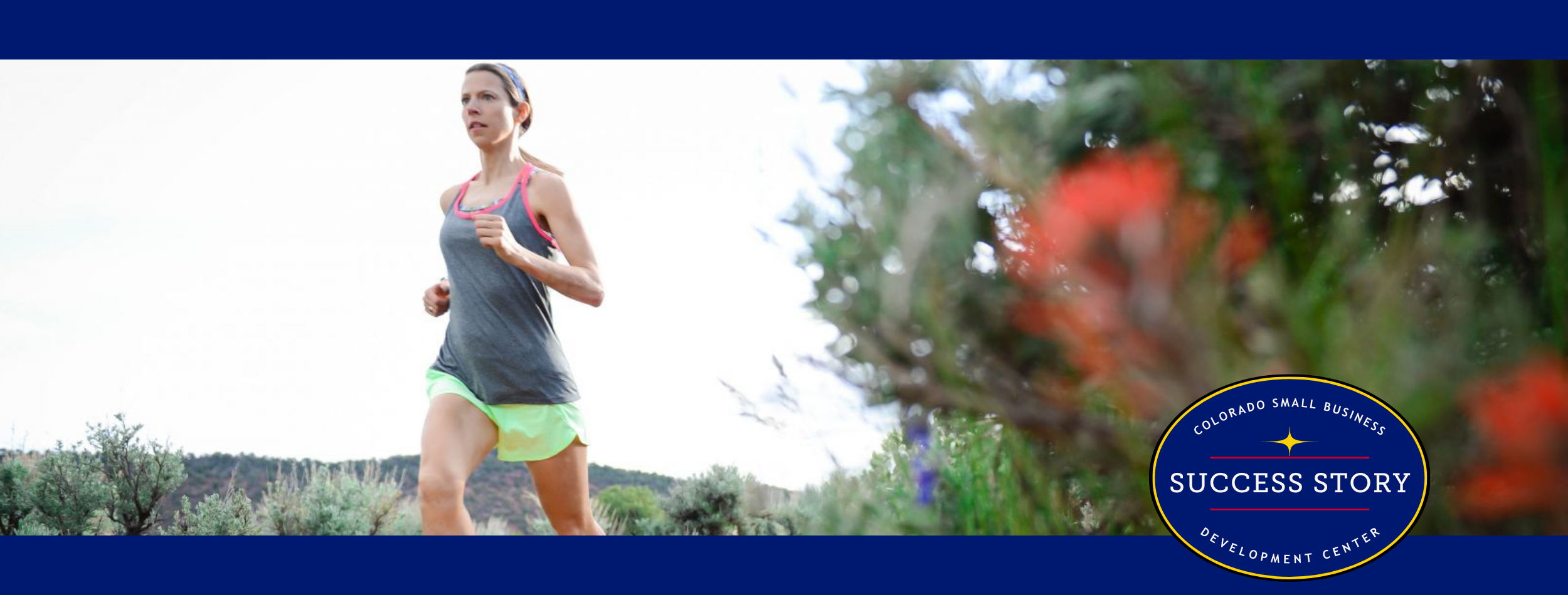 a person running on a trail in the mountains.