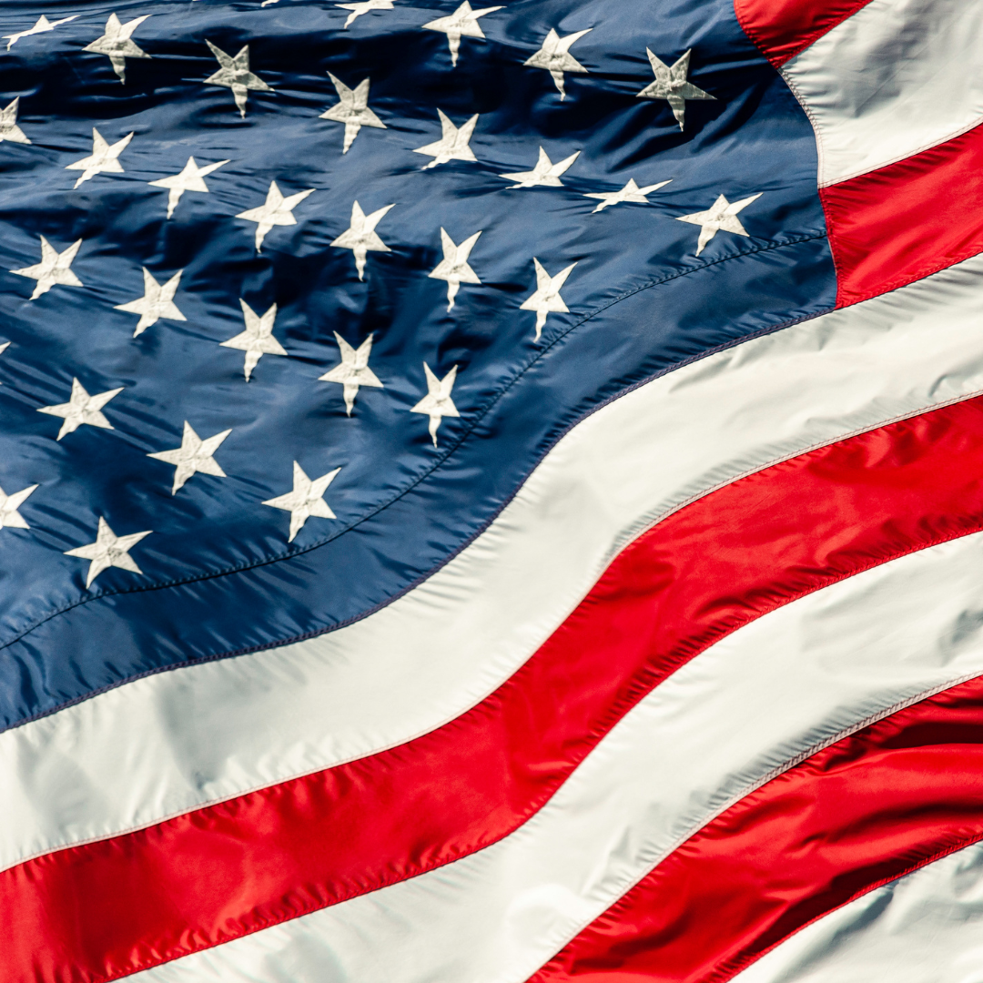 an american flag blowing in the wind.