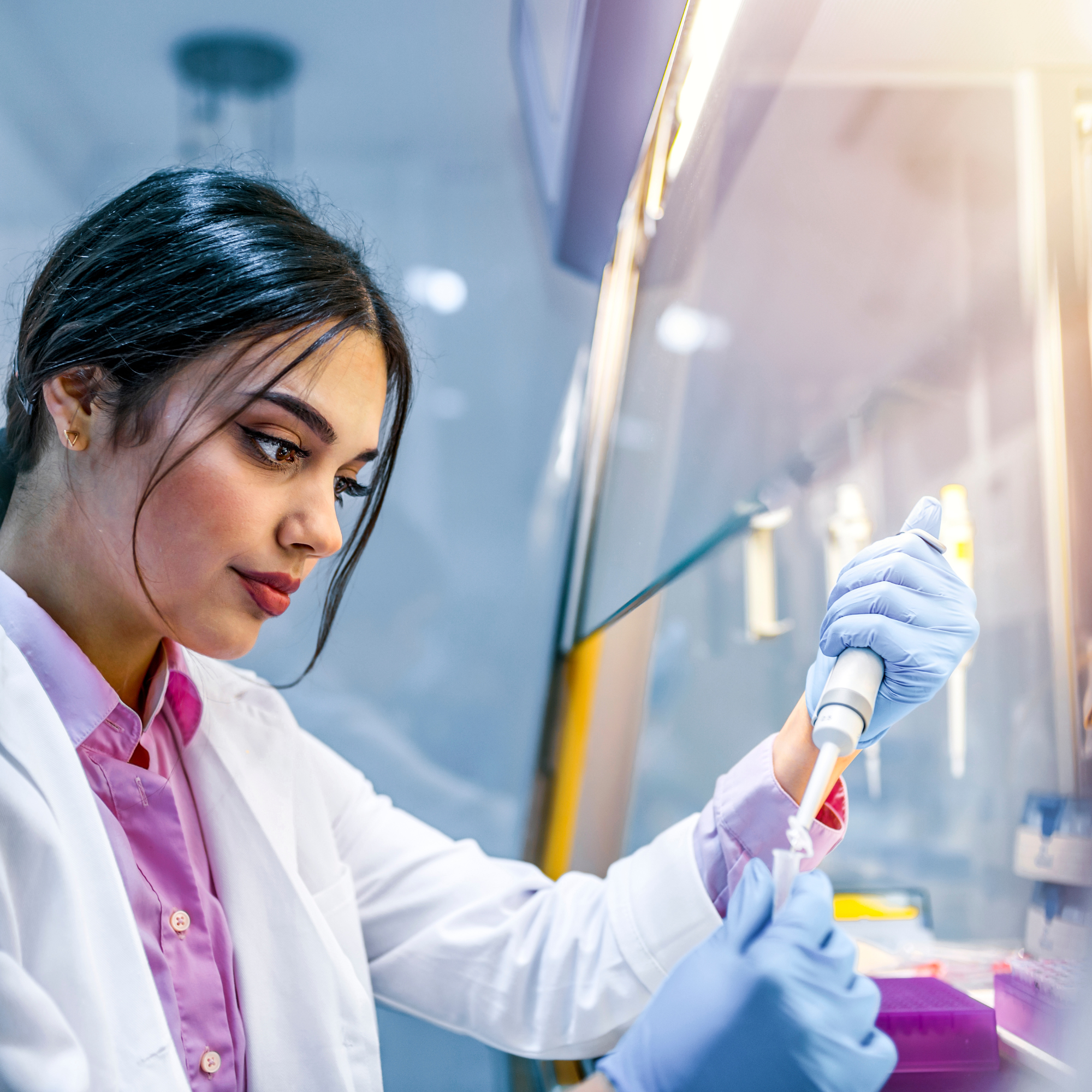 a person in a lab coat is working on something.