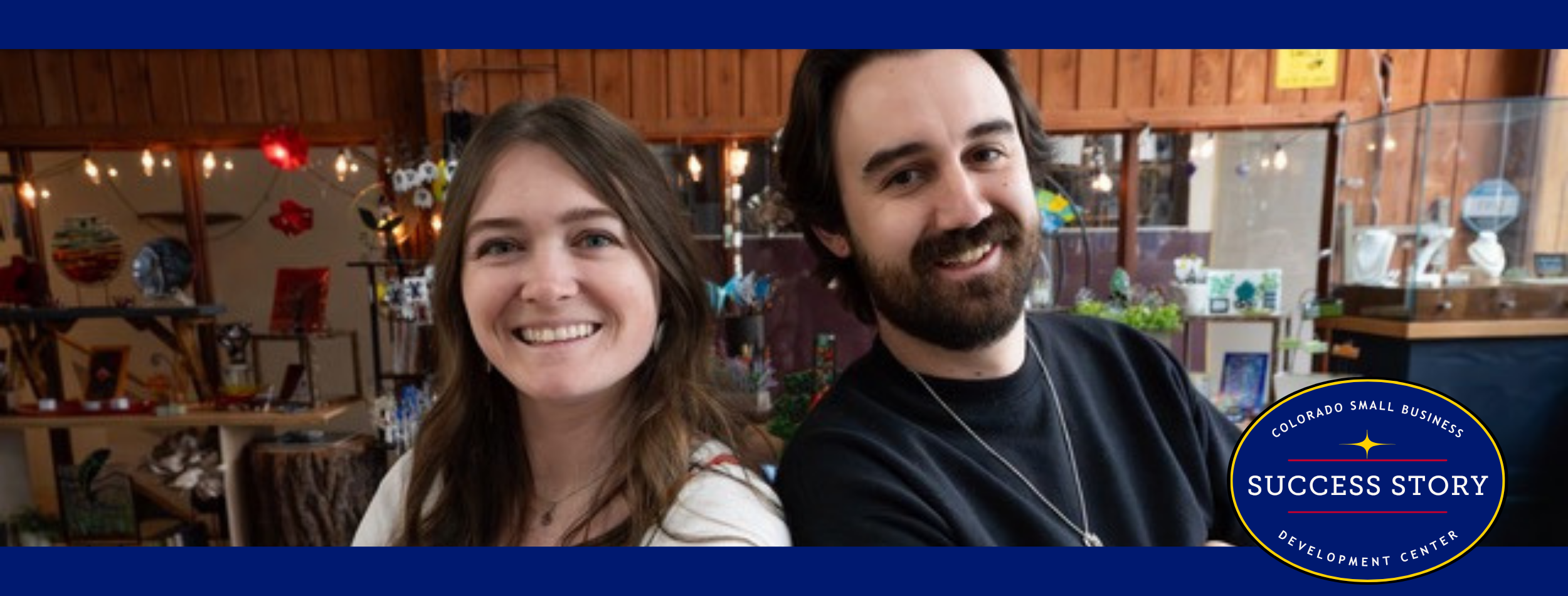 Two people are posing for a photo in a store.