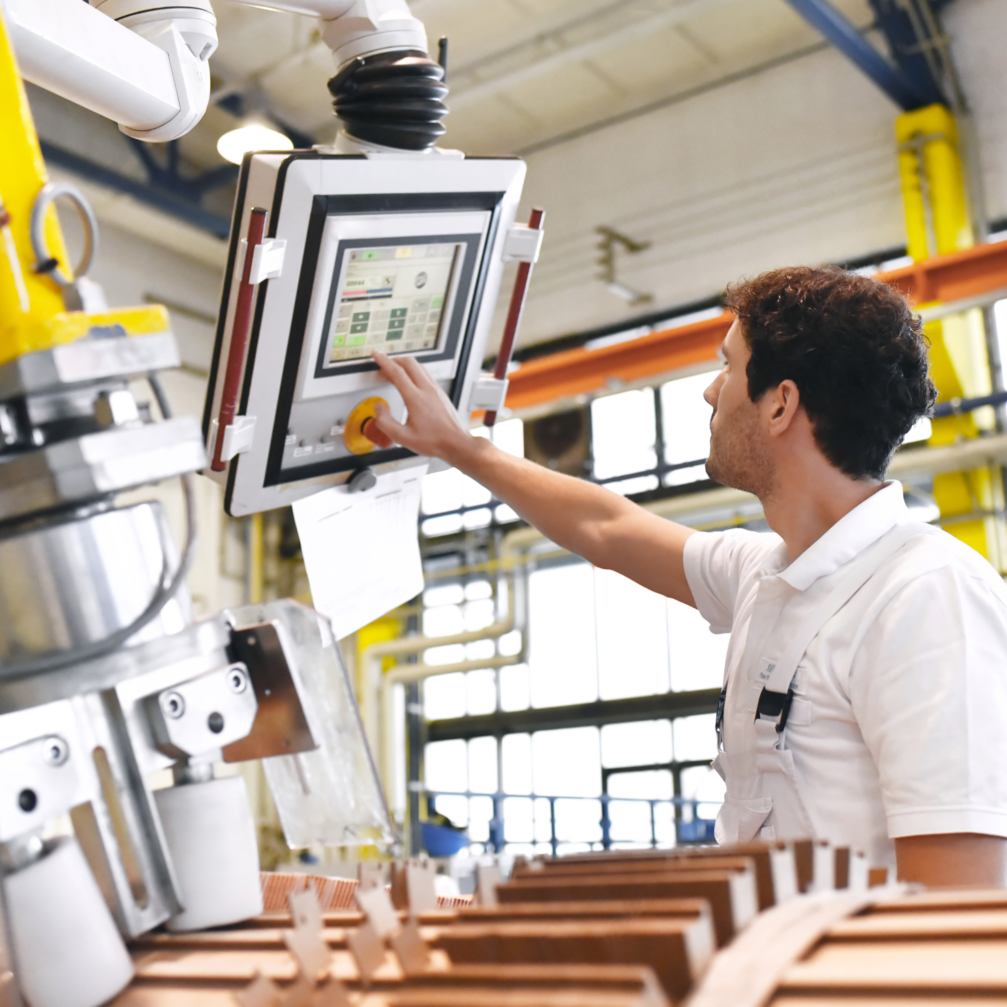 A person is working on .a machine in a factory
