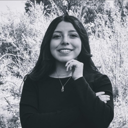a black and white photo of a person smiling.