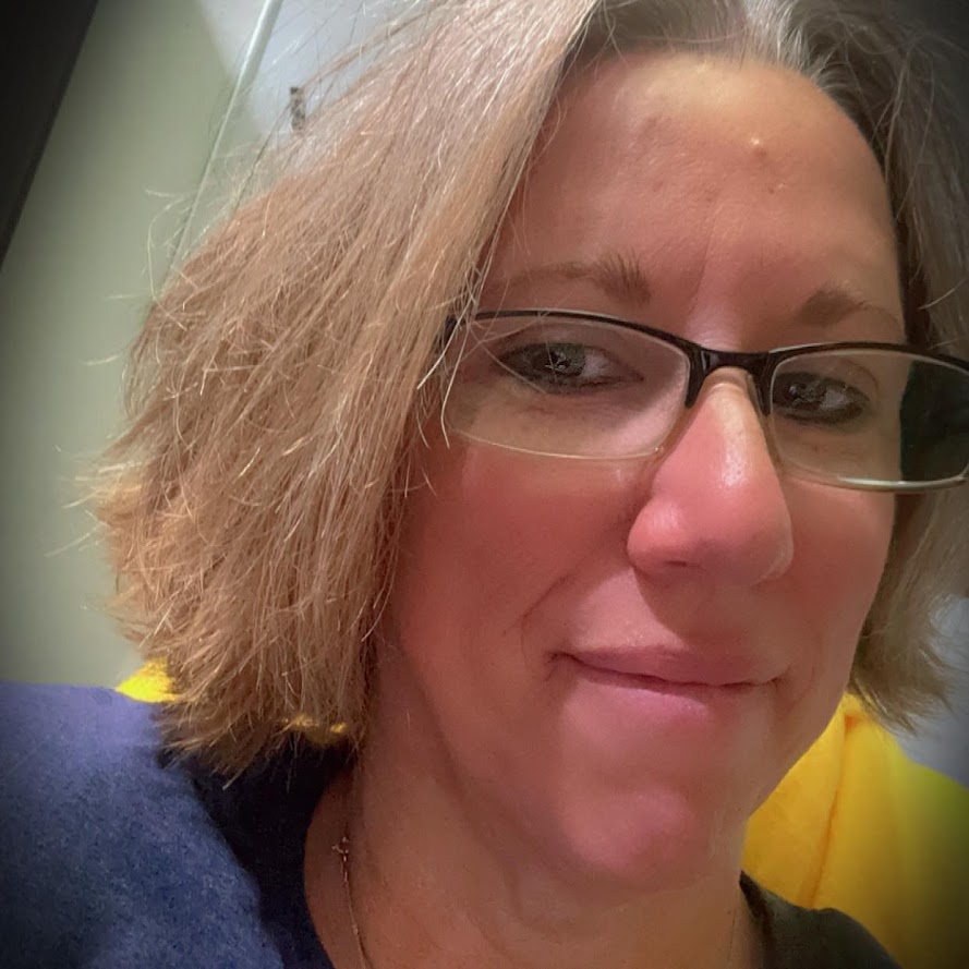 a person wearing glasses and a blue shirt.