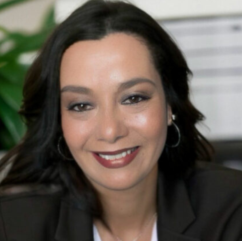 a person in a business suit smiling at the camera.