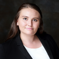 woman in black blazer and white shirt.
