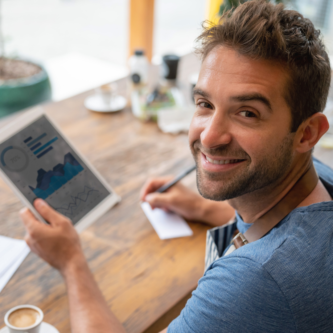 a person is smiling while using a tablet computer.