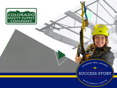 a person strapped into safety gear wearing a yellow helmet.