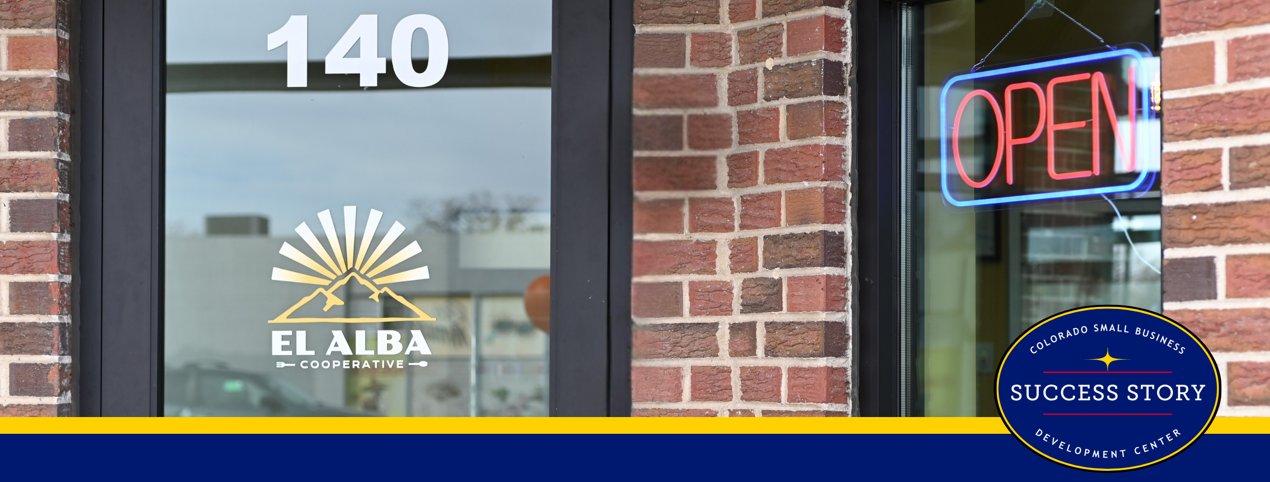 A building entrance with the number 140 above a glass door. A neon open sign is displayed in the window.