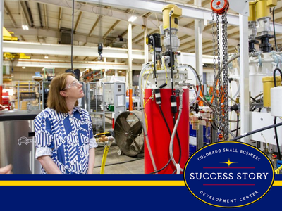 a person standing in front of a machine in a factory.