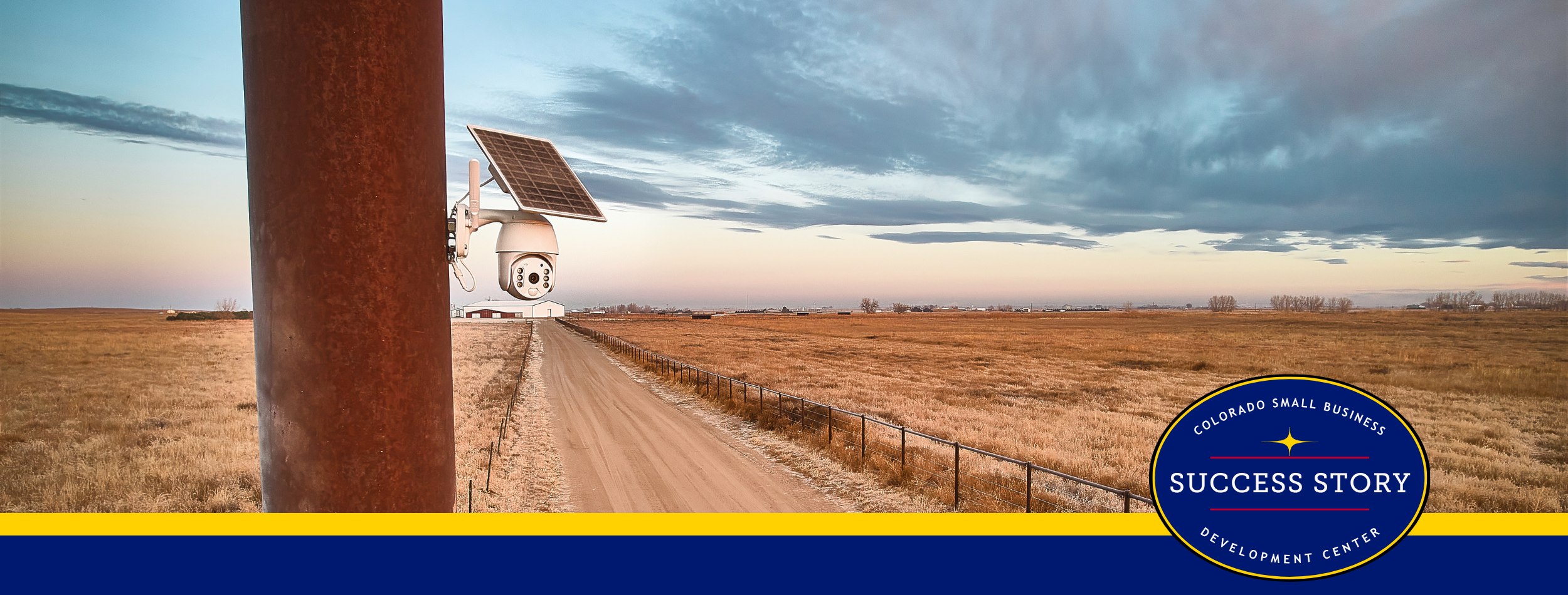 a pole with a solar panel on it in the middle of a dirt road.