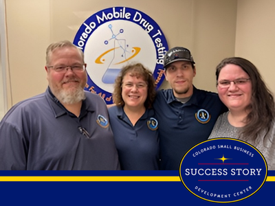 Image of business owners standing in front of business logo with two adult children involved with the business