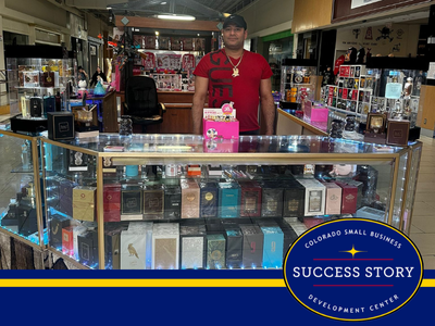 a person standing in front of a display of perfumes.