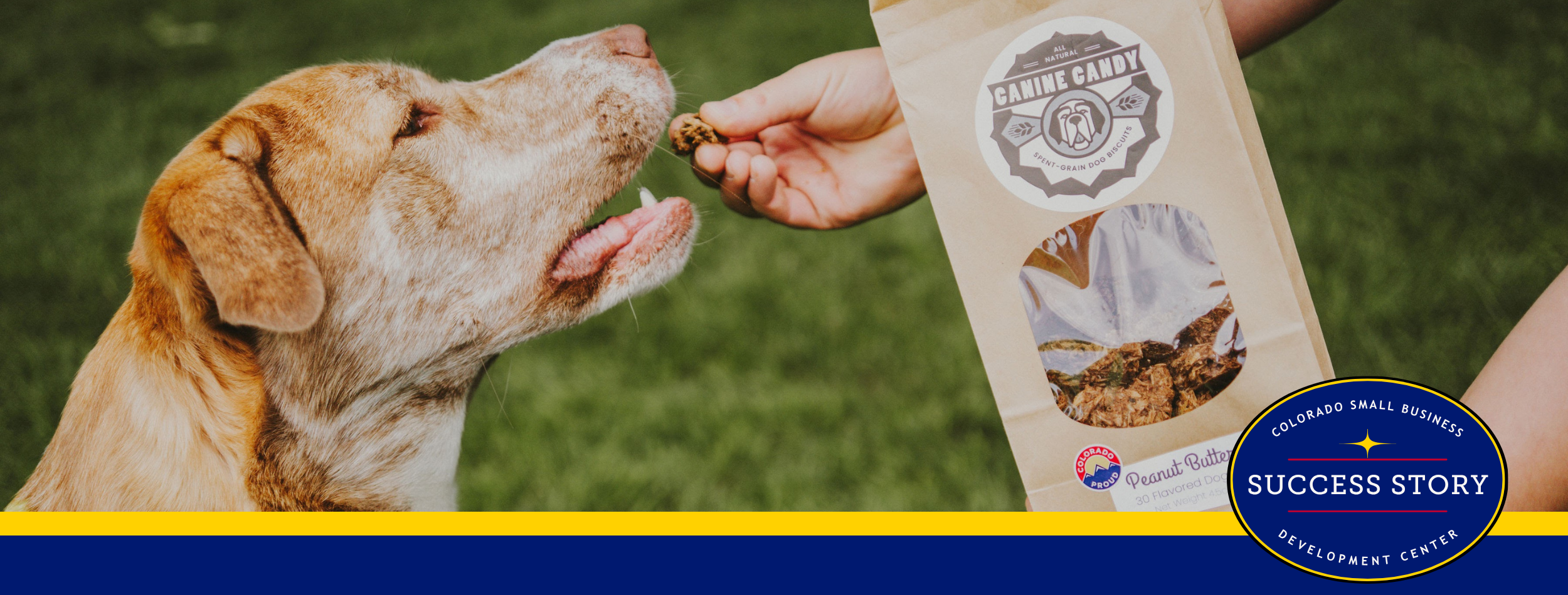 A person feeding a dog a bag of dog food.