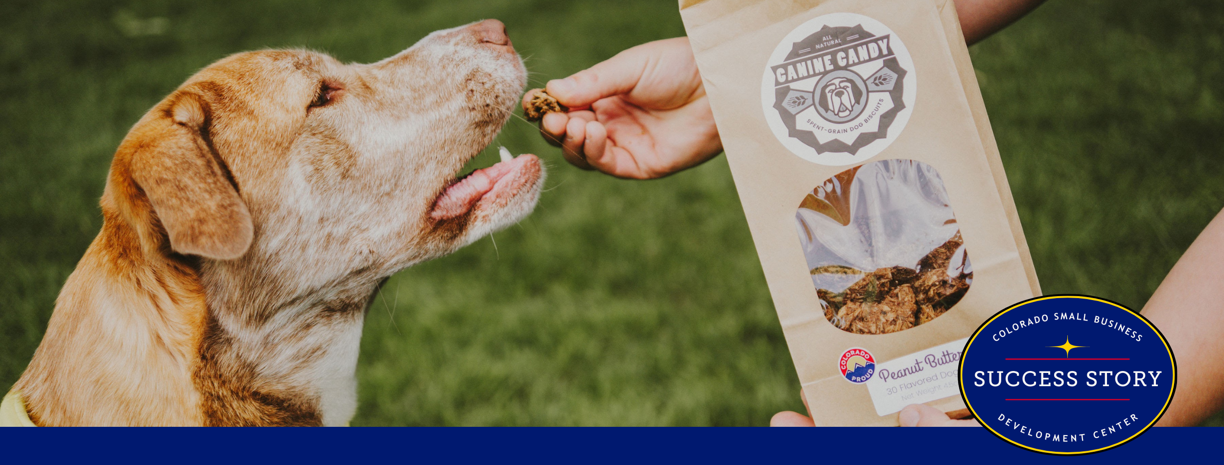 A person feeding a dog a bag of dog food.