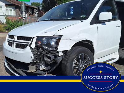 a damaged van is parked on the side of the road.