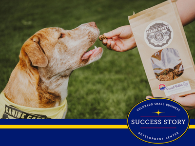 A person feeding a dog a bag of dog food.