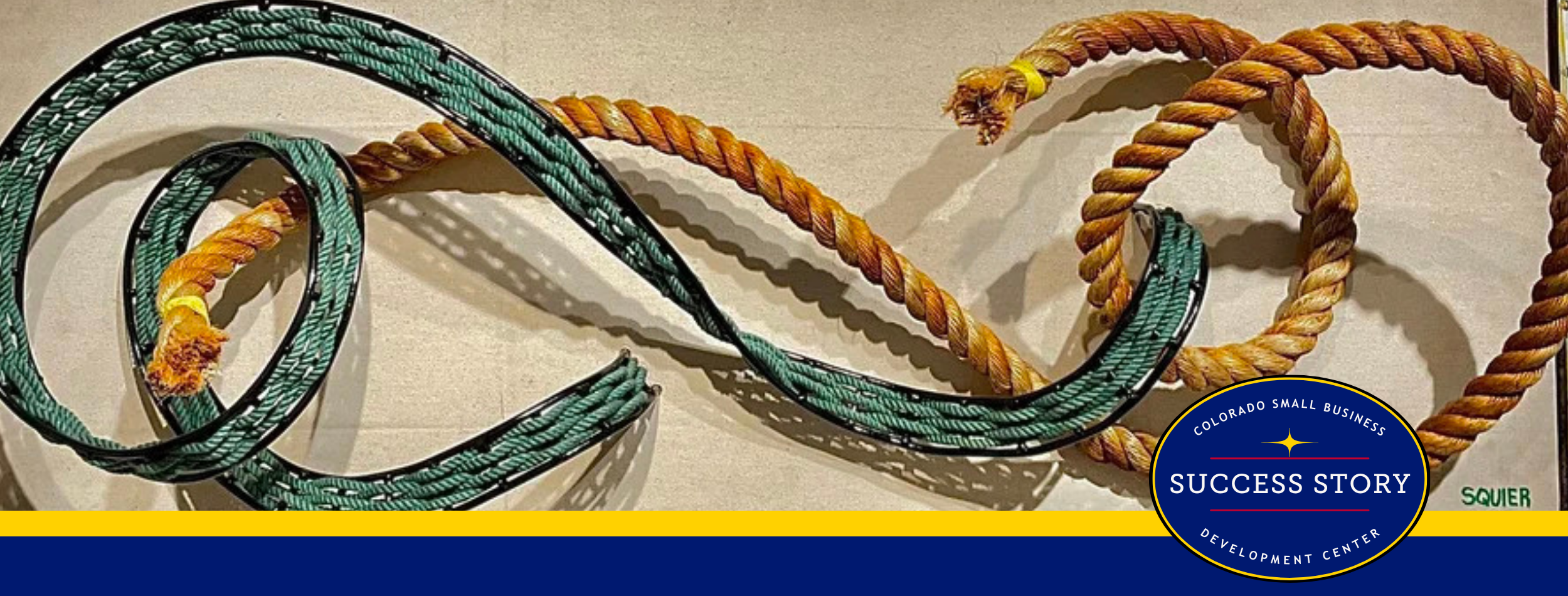 Two thick ropes, one orange-brown and one teal, are intertwined in a flowing, abstract design. The artwork is signed 'SQUIER' in the bottom right corner.