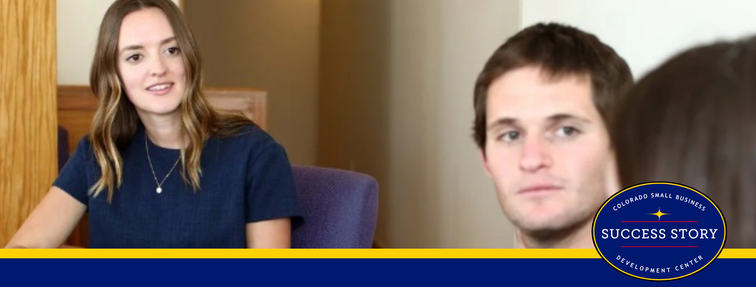 A counselor listening to two people sitting at a table talking to each other.