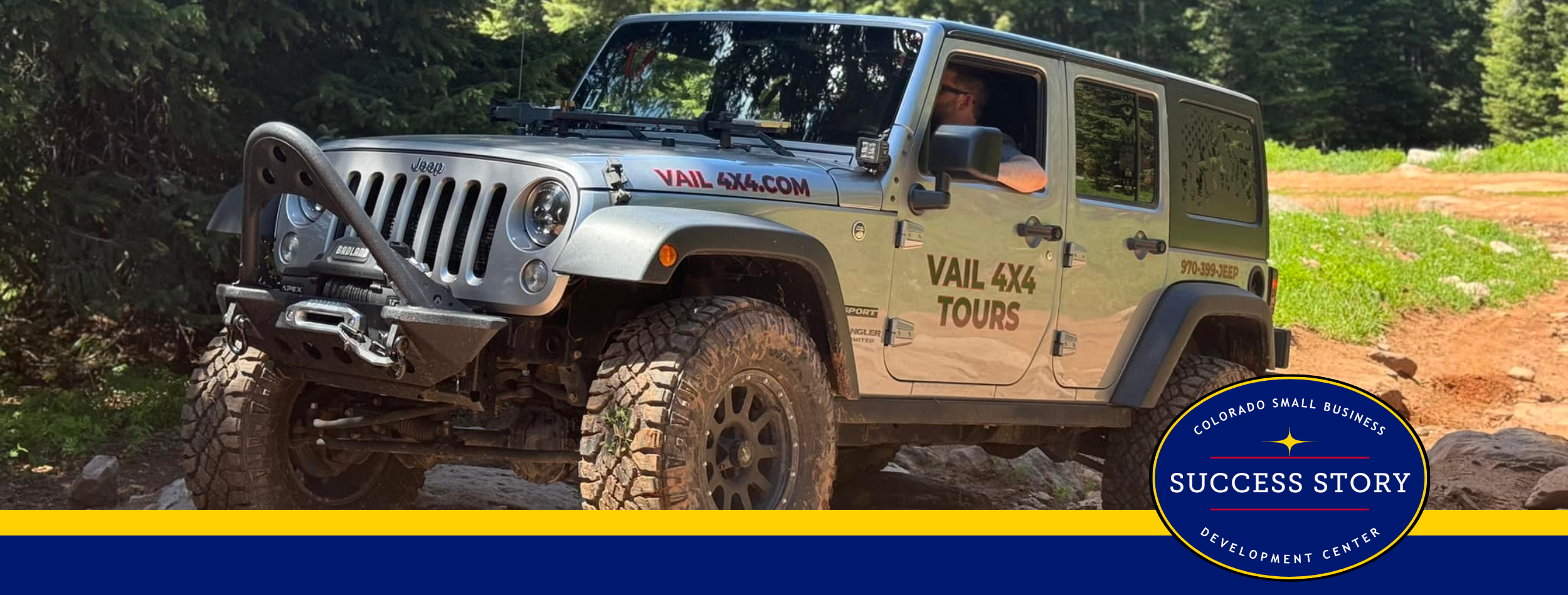 a jeep driving on a trail in the woods.