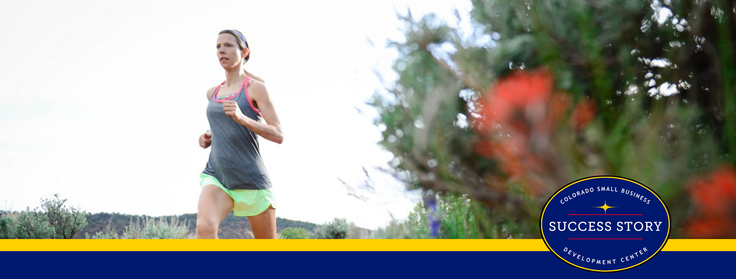 a person is running on a trail through wildflowers.