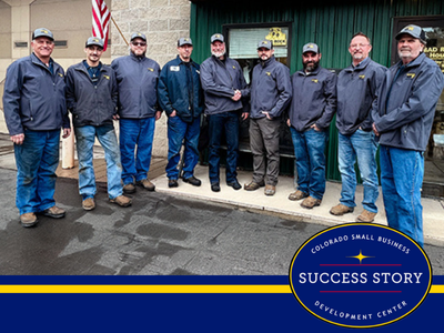 a group of people standing in front of a building.