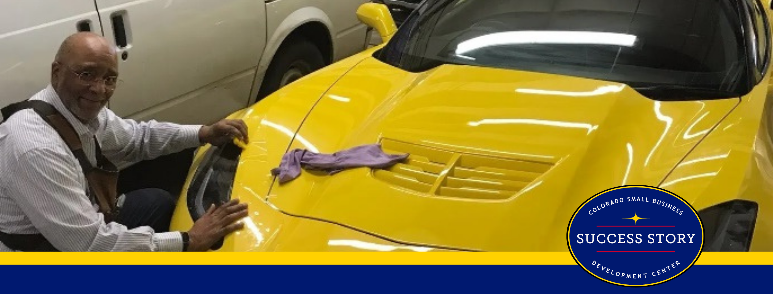 a person is working on a yellow sports car.