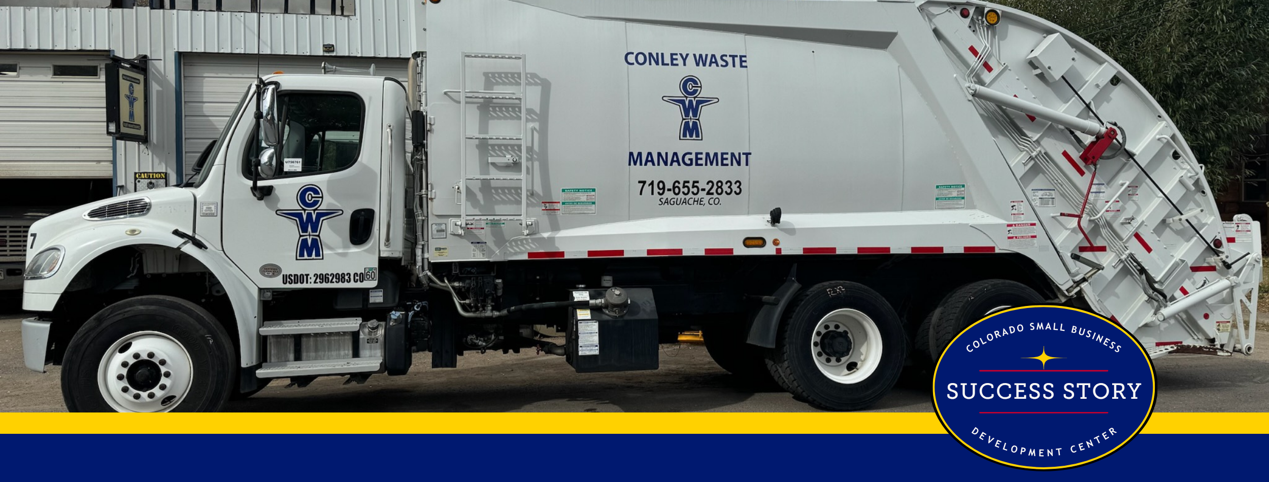a garbage truck parked in front of a building.
