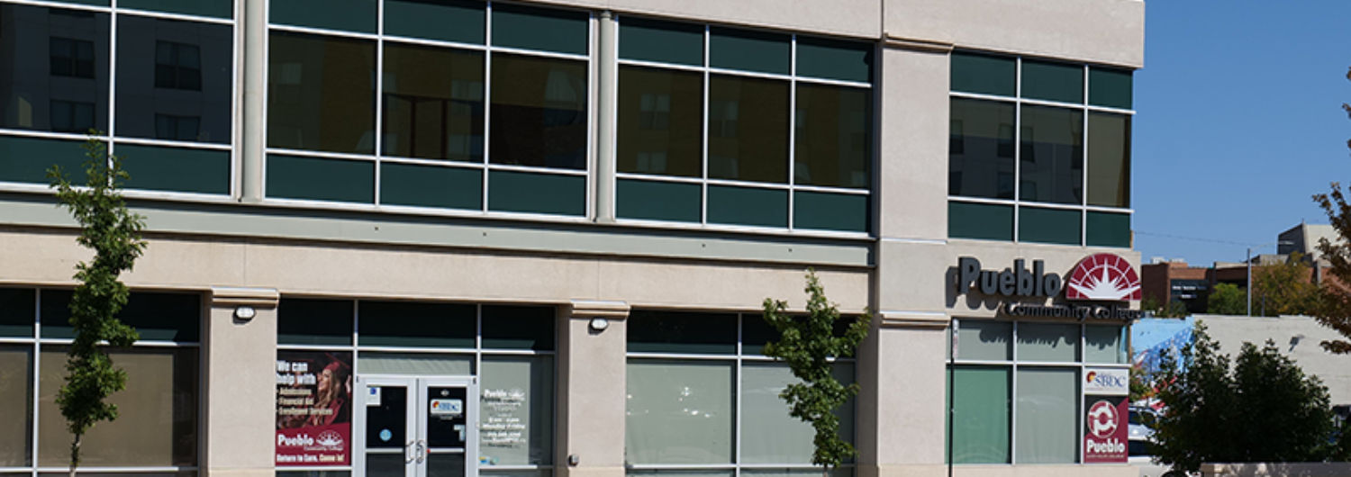 a tree in front of a the Colorado SBDC building in Pueblo.