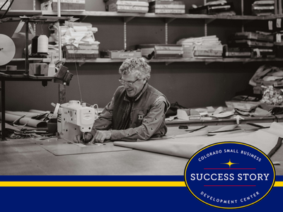 a black and white photo of a person working on a sewing machine.