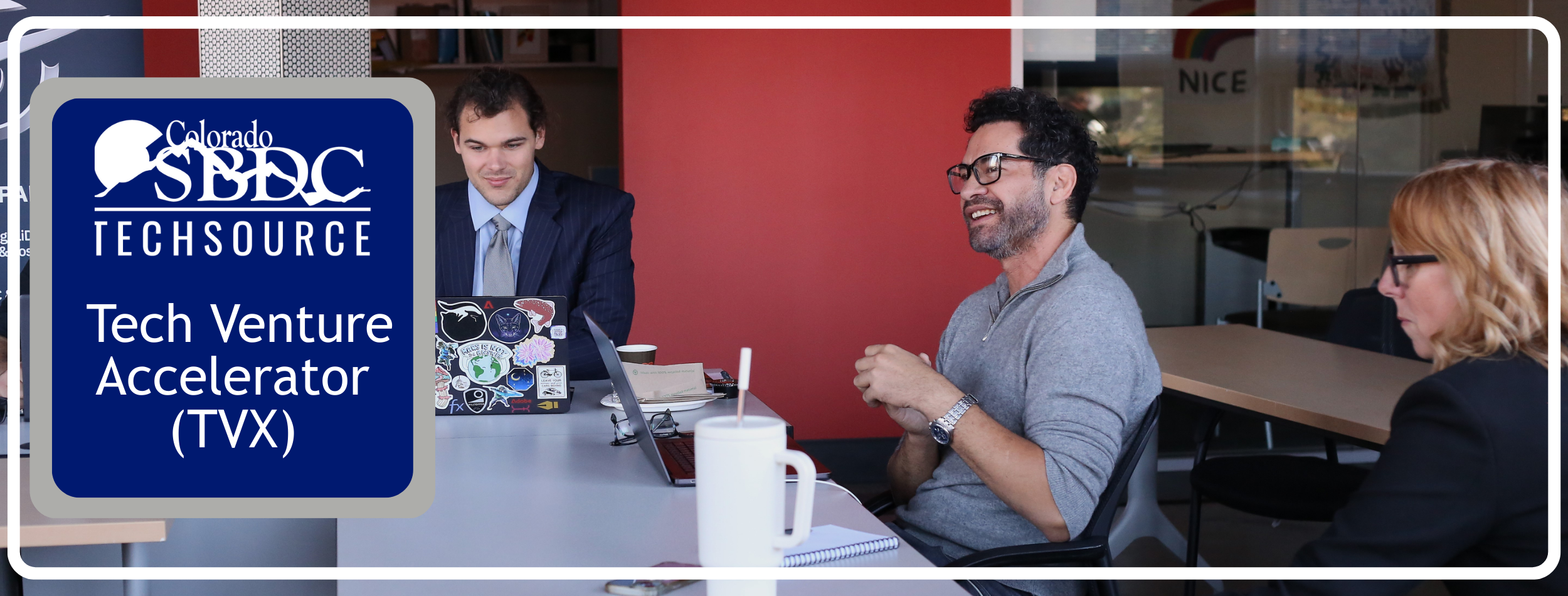 two men and a woman engaged in conversation with the text Tech Venture Accelerator (TVX) over it