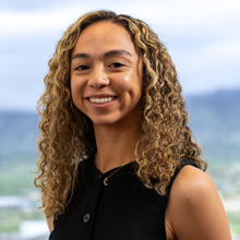 person in black top smiling 