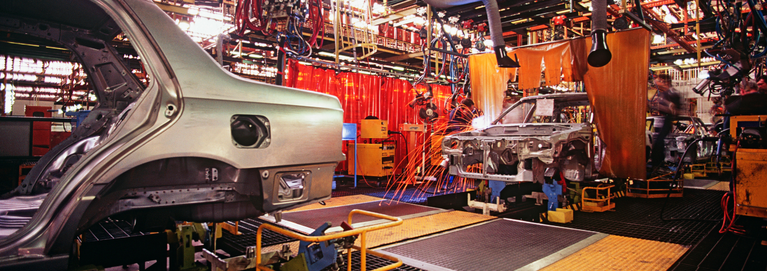 A car is being worked on in an assembly line.